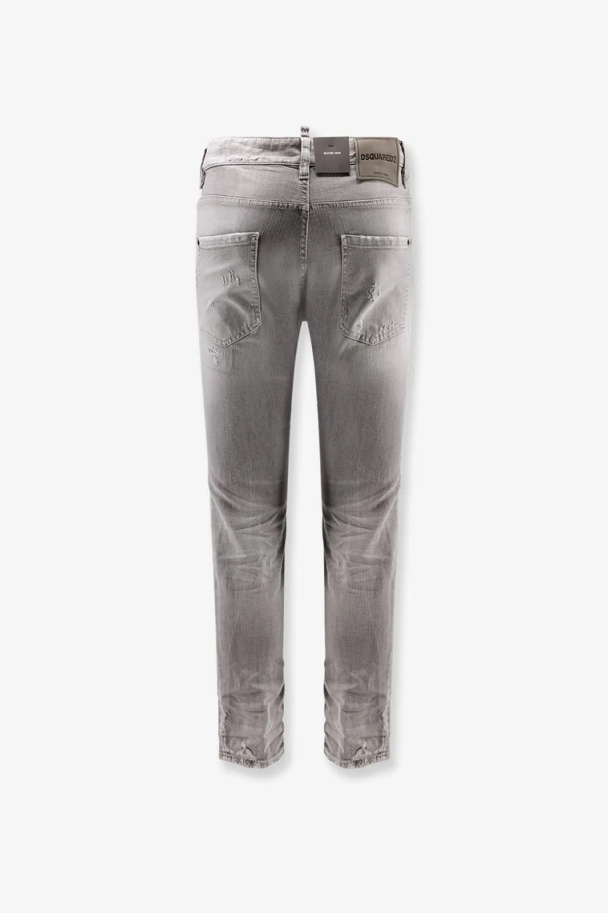 Back view of dsquared2 men’s skater jeans in grey distressed slim fit denim with frayed cuffs and brand label on waistband