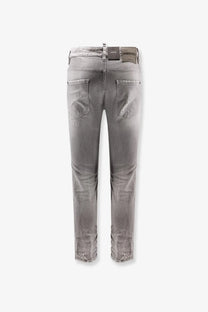 Back view of dsquared2 men’s skater jeans in grey distressed slim fit denim with frayed cuffs and brand label on waistband
