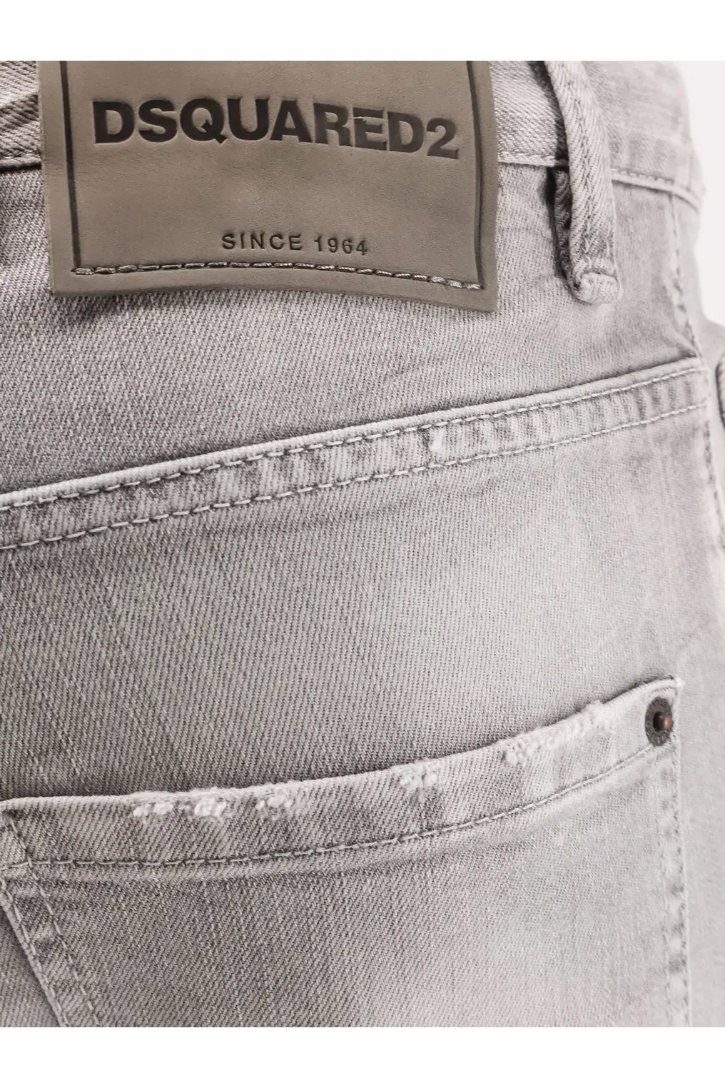 Light gray distressed denim Dsquared2 men’s skater jeans showing back with brand label and casual style