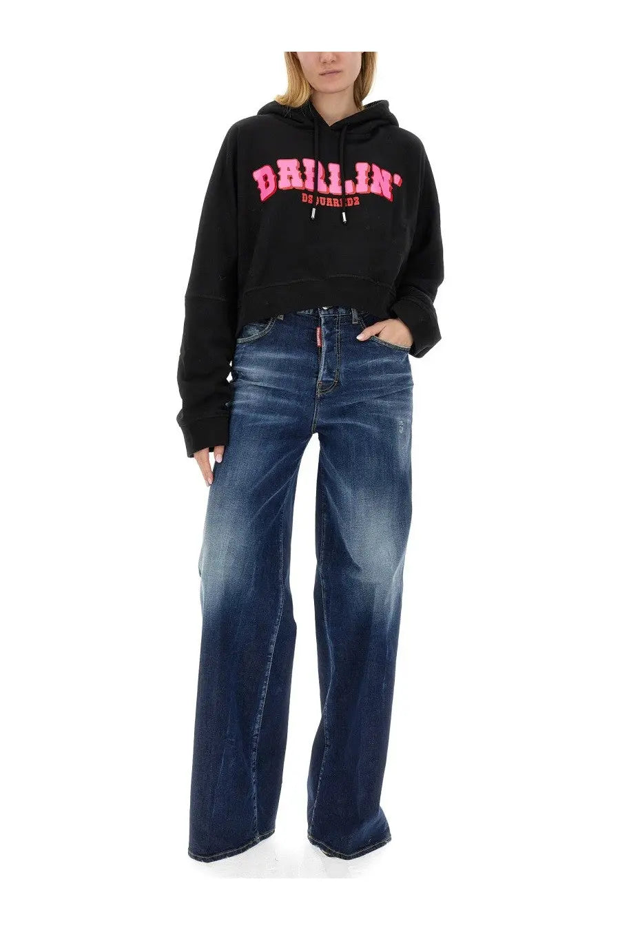 Black cropped hoodie with bold pink drillin lettering and small dsquared2 logo on waistband paired with blue traveller jeans