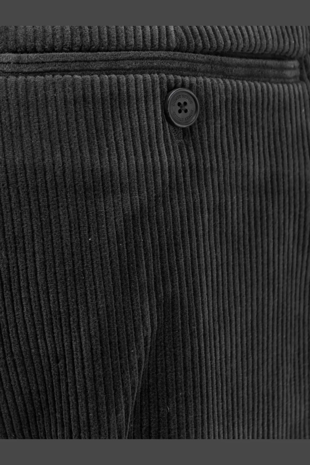 Black corduroy trousers by dunst featuring textured ribbed fabric and a matching black four-hole button