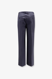 Dark navy blue dunst men’s pleated chino slacks trousers with tailored fit and buttoned back pockets shown from the back