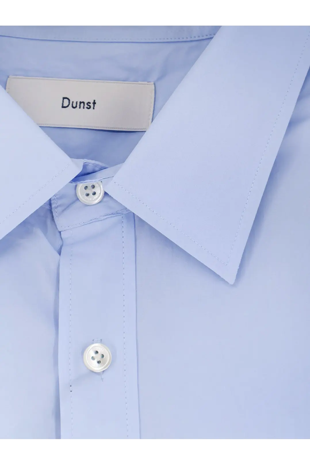 Dunst men’s unisex cotton shirt blue featuring a light blue button-down design with a crisp collar and white buttons