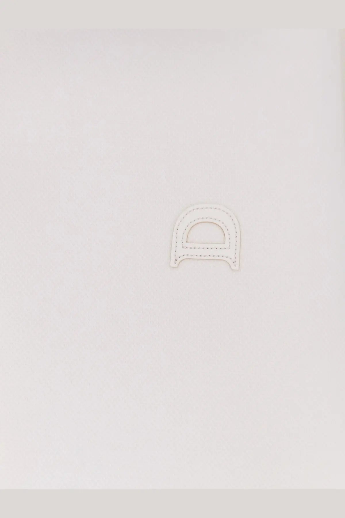 White leather letter d charm with stitched edges on dunst men’s unisex polo shirt white