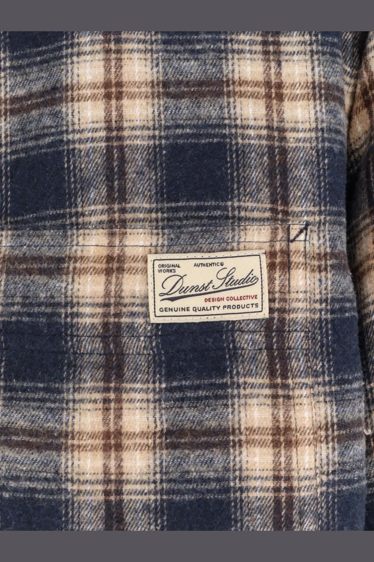 Dunst unisex madras pattern flannel jacket in navy blue and beige plaid with darnst studio label on chest