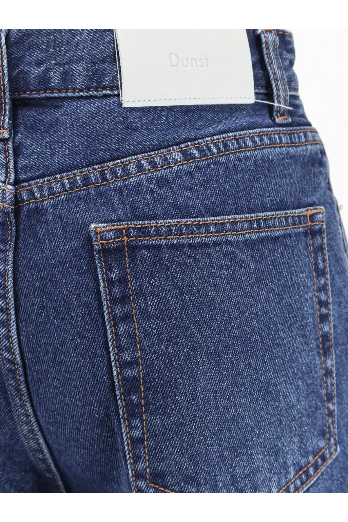 Dunst women’s blue denim jeans with dark blue material and white dunsi brand label at the waistband