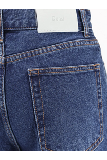 Dunst women’s blue denim jeans with dark blue material and white dunsi brand label at the waistband