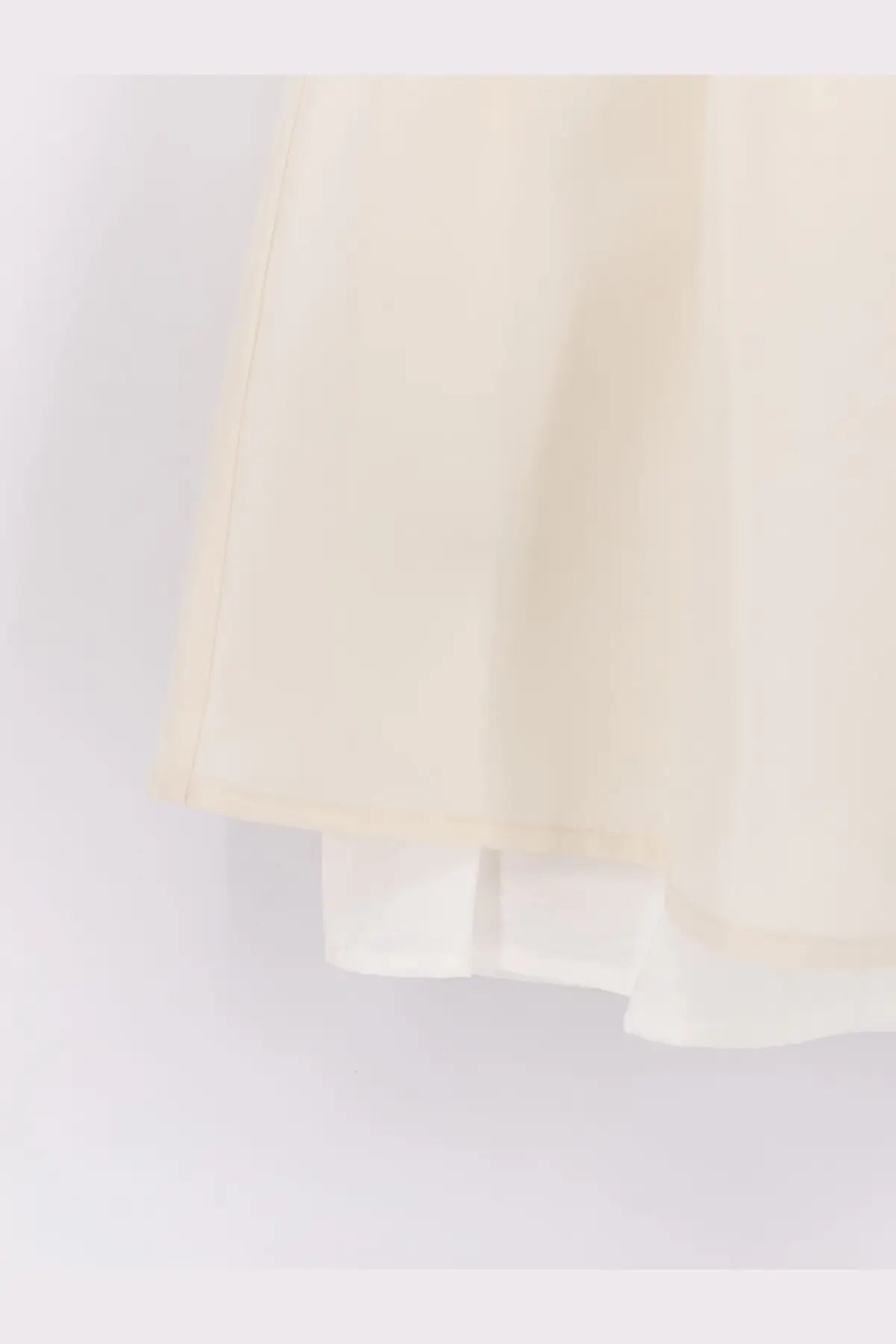 Dunst women’s layered volume mini skirt in white with flowing cream lightweight semi-transparent fabric and layered hemline