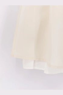 Dunst women’s layered volume mini skirt in white with flowing cream lightweight semi-transparent fabric and layered hemline