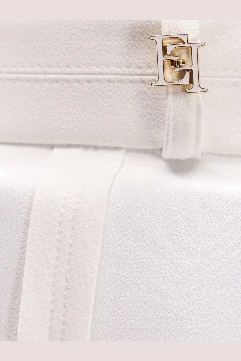 White leather handbag with gold-tone metallic logo clasp paired with elisabetta franchi womens celana daily trousers white