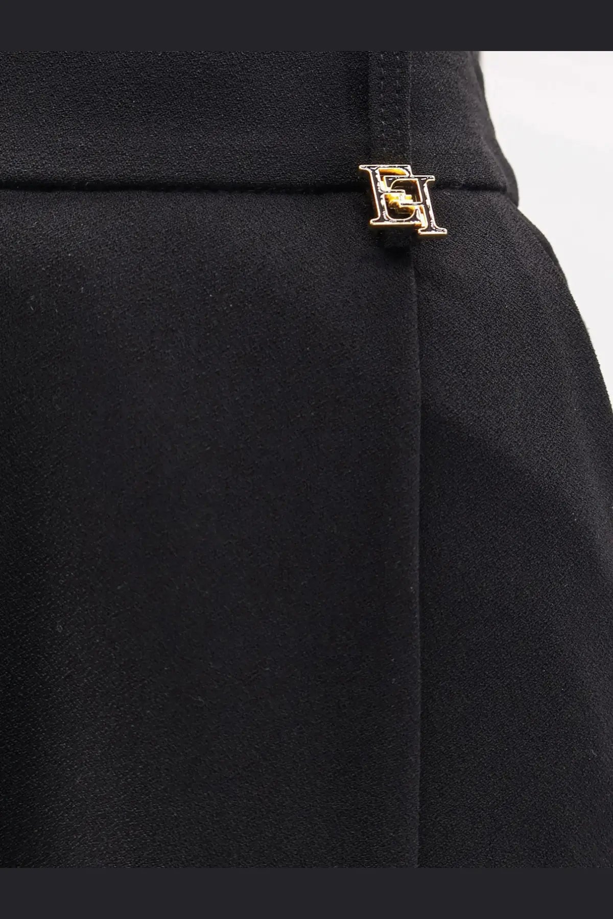 Black high-waisted skirt with gold-tone metallic logo pin at waistband from elisabetta franchi women’s essentials stretch trousers