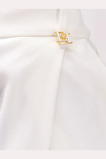 Gold-tone metallic logo clasp with interlocking h design on white fabric of elisabetta franchi women’s essentials stretch trousers