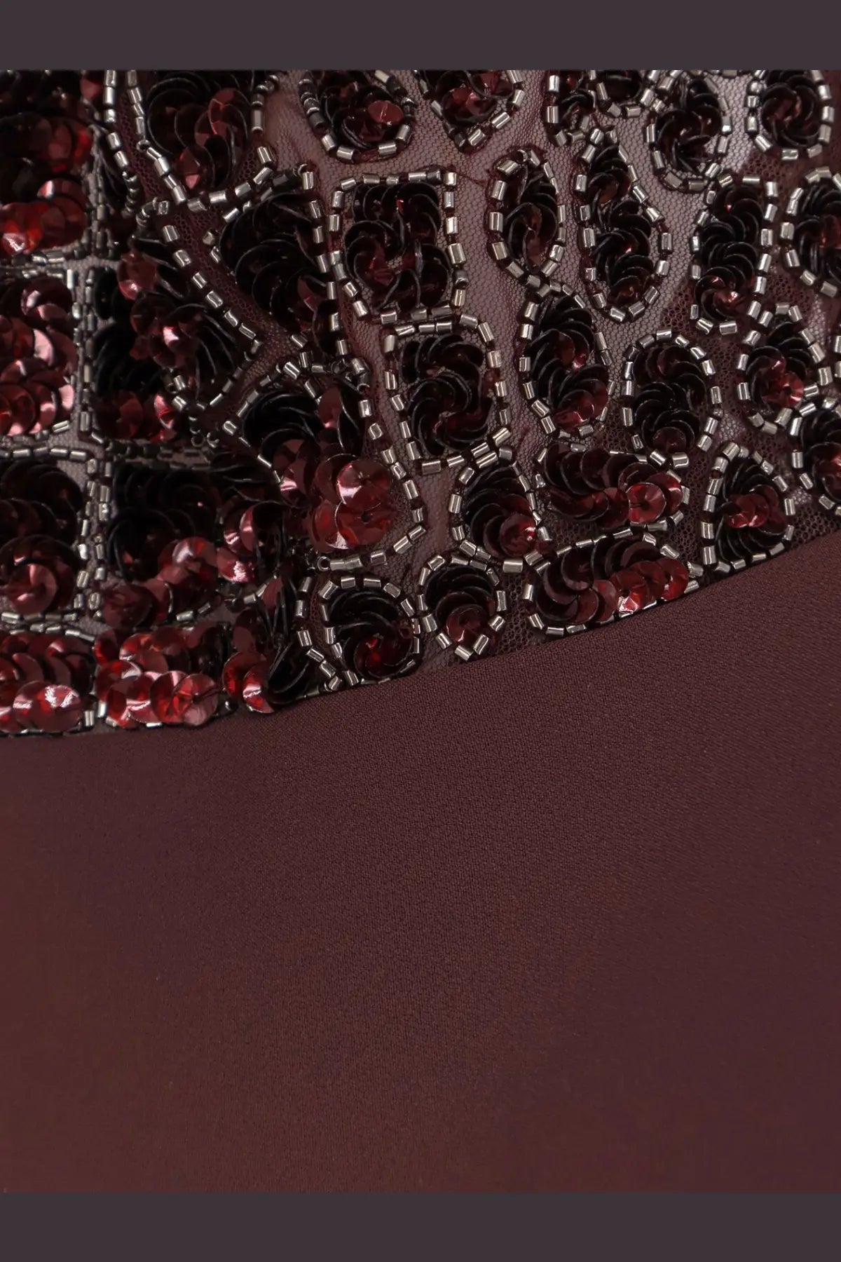 Dark burgundy dress with sheer sequined bodice and intricate red and black floral patterns by elisabetta franchi