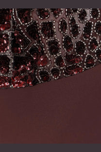 Dark burgundy dress with sheer sequined bodice and intricate red and black floral patterns by elisabetta franchi
