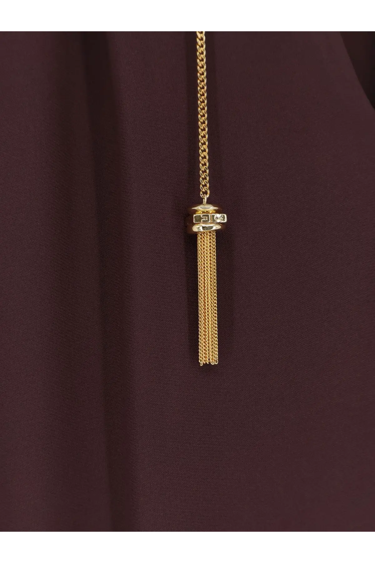 Gold chain necklace with tassel pendant featuring small rectangular stones worn with elisabetta franchi brown viscose shirt