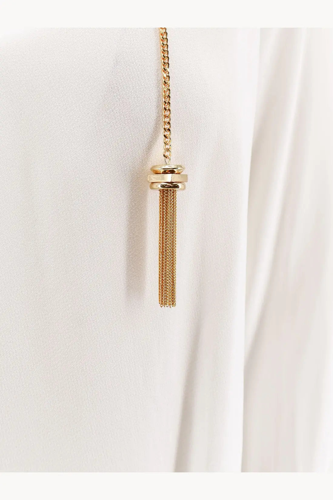 Gold-toned chain necklace with cylindrical cap and delicate mesh tassel paired with white Elisabetta Franchi viscose shirt