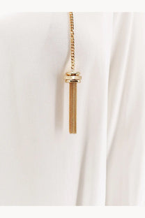 Gold-toned chain necklace with cylindrical cap and delicate mesh tassel paired with white Elisabetta Franchi viscose shirt