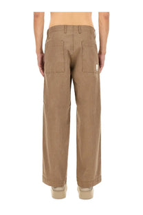 Back view of tan wide-leg chino pants with two back pockets and white label on right pocket from emporio armani
