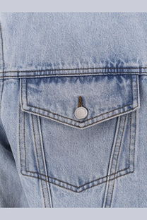 Entire Studios men’s denim jacket blue featuring a light-wash denim pocket with silver button closure detail