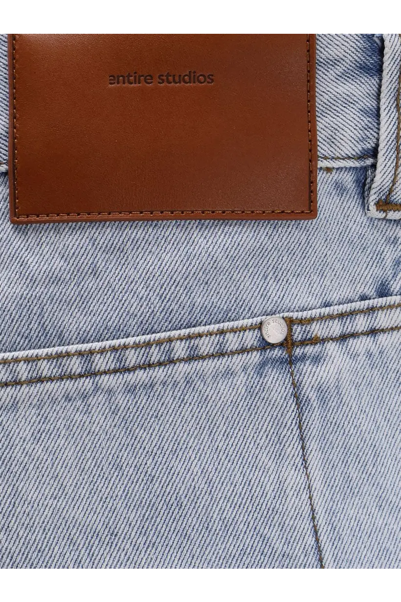 Light-wash cotton denim jeans with brown leather entire studios patch on the back for men in blue