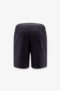 Black cotton bermuda shorts by entire studios shown from the back with an elastic waistband and single rear pocket