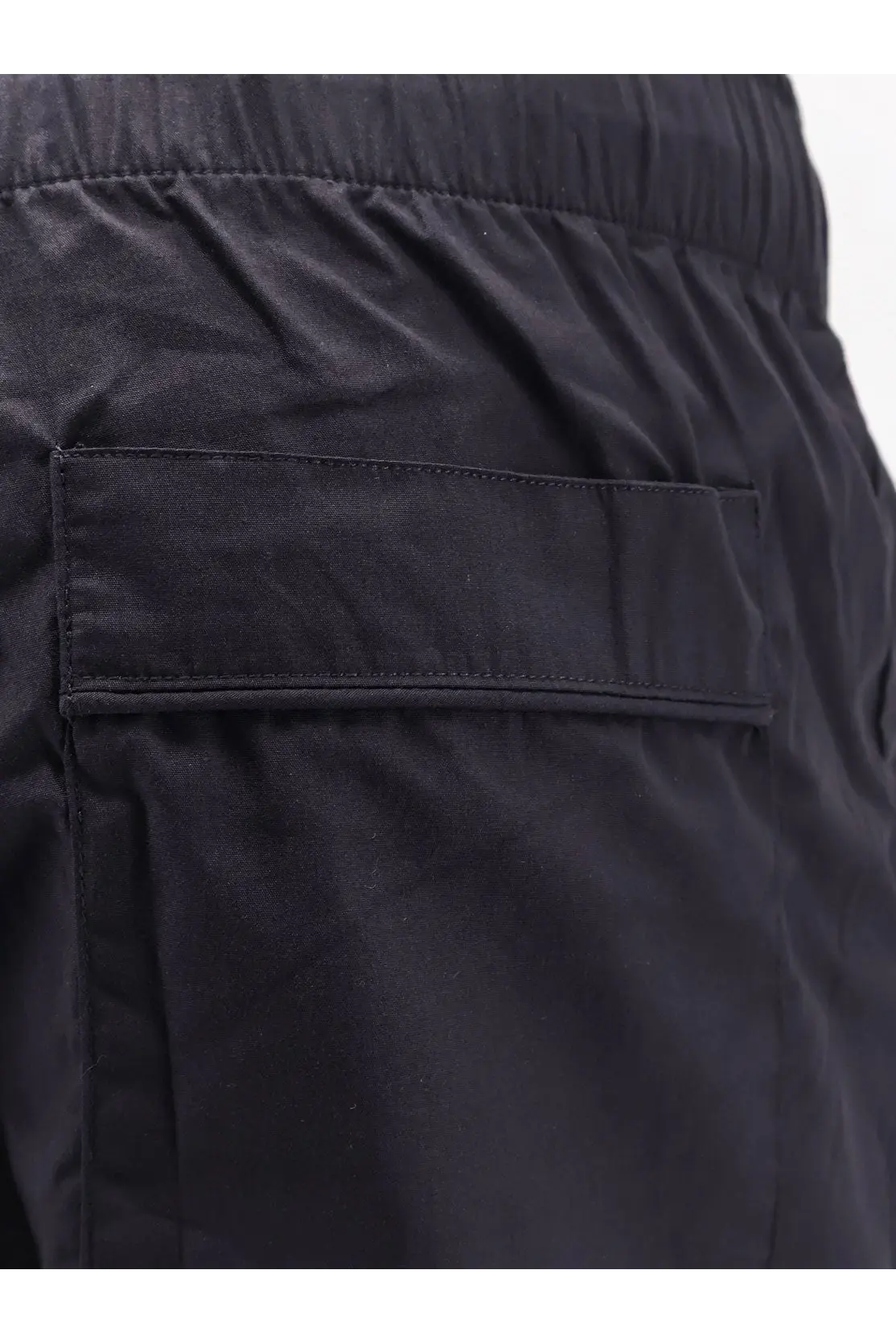 Entire Studios unisex black cotton bermuda shorts with drawstring waistband and a single rectangular patch pocket