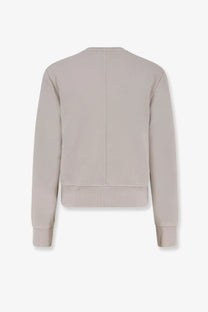 Beige knit sweater with ribbed cuffs and hem showing central seam down the back from entire studios unisex pod crew cotton shirt white