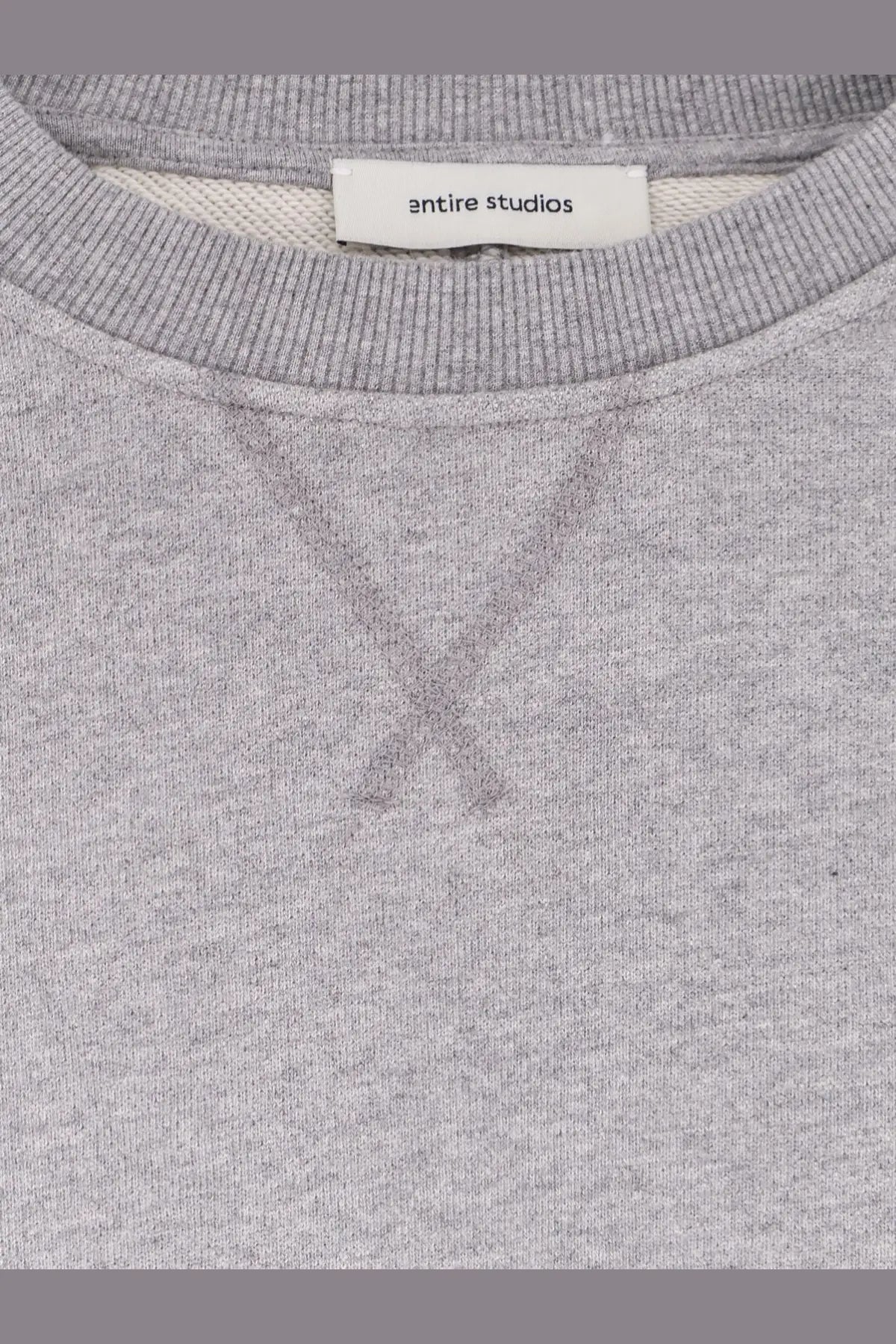 A heather gray unisex pod crew cotton sweatshirt with ribbed collar and entire studios brand label