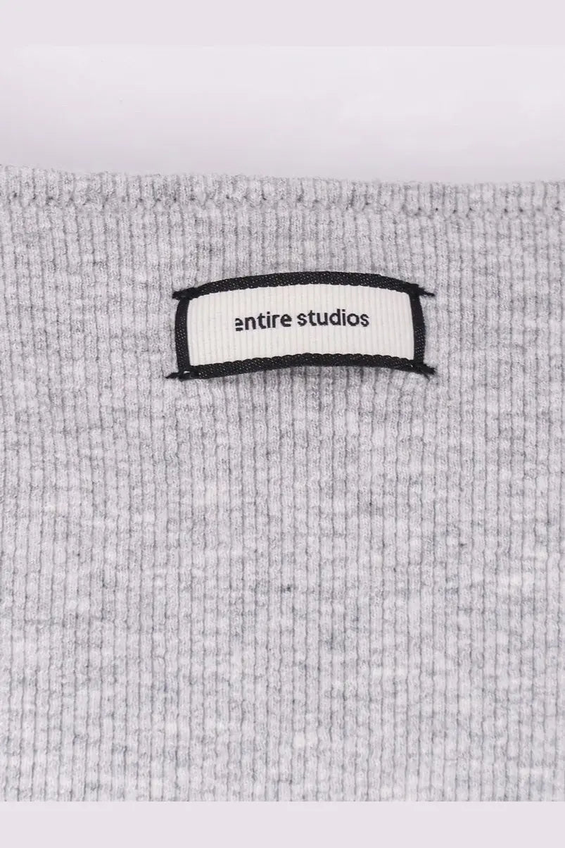 Gray ribbed knit cotton blend sweater with entire studios label in black text on white for women pebble color