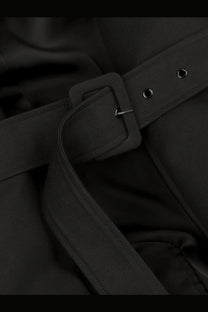 Black cotton fabric belt with rectangular buckle and silver hardware featured on entire studios women’s mini scarf coat