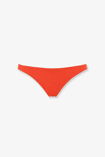 Bright orange Eres women’s lycra bikini bottom with a smooth seamless design shown from the front side