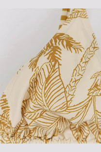 Eres women’s nylon bikini top in cream with golden tropical leaf pattern and striped shoulder straps