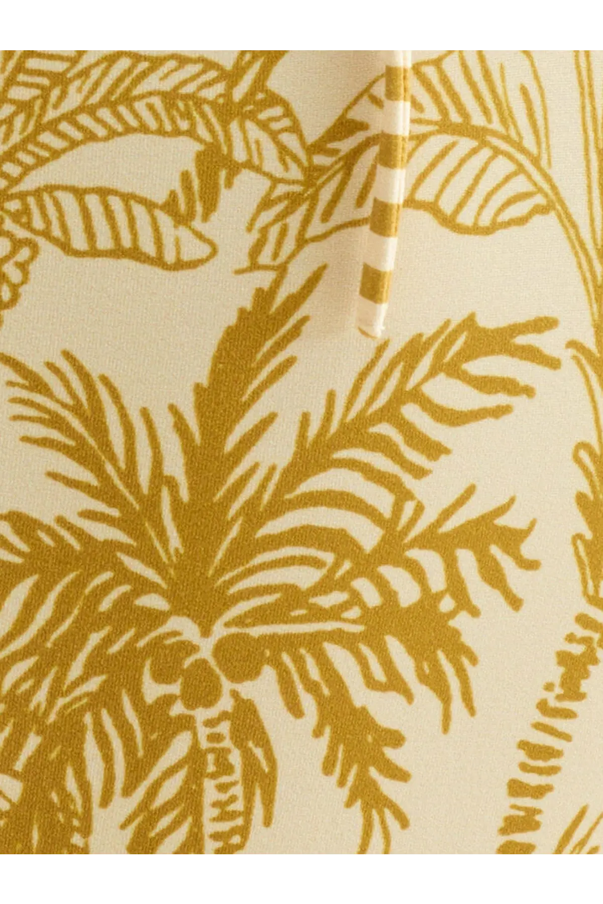 Eres women’s one piece swimsuit in cream fabric with bold golden yellow tropical palm tree pattern