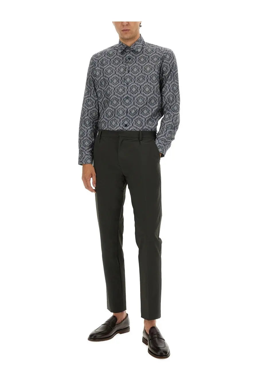 A man wearing etro men’s multicolor cotton shirt with dark gray and navy geometric patterns and black tailored trousers