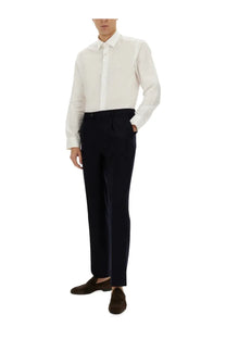 Etro men’s pegasus white long-sleeved dress shirt with subtle chest embroidery paired with dark navy trousers