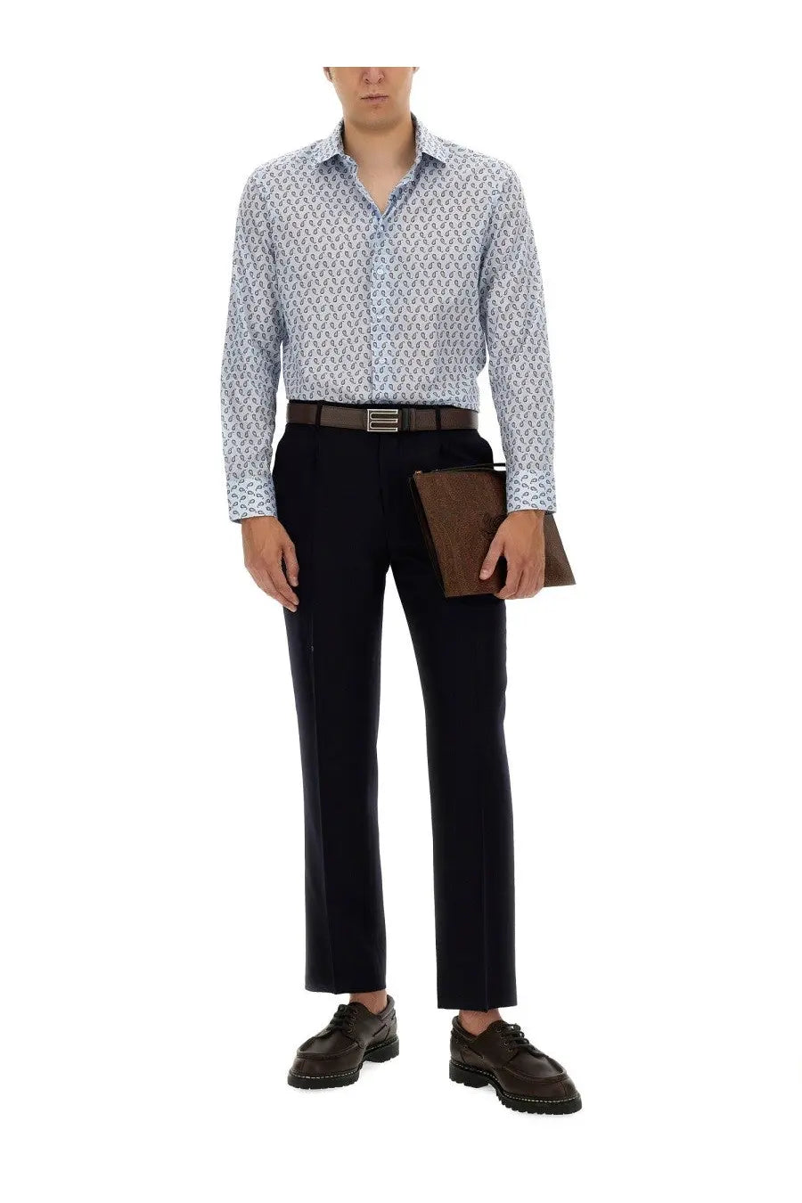 A man wearing etro men’s rome blue long-sleeve button-down shirt with light blue and white pattern and navy trousers