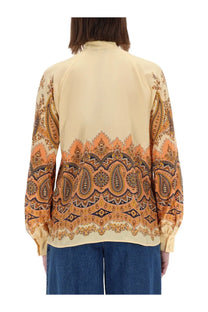 Etro women’s cream blouse with vibrant orange and brown paisley pattern featuring long sleeves and high collar