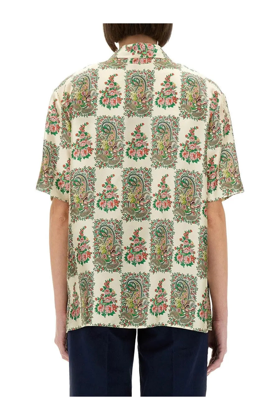 A cream-colored etro women’s silk shirt with short sleeves and green and pink floral paisley pattern