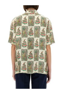 A cream-colored etro women’s silk shirt with short sleeves and green and pink floral paisley pattern