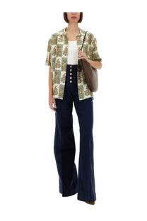 A woman wears etro women’s silk multicolor short-sleeved button-up shirt with muted green and pink floral pattern