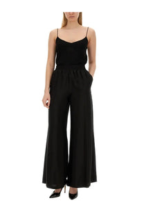 Fabiana Filippi women’s black viscose top paired with a black satin slip jumpsuit with wide-leg pants and spaghetti straps