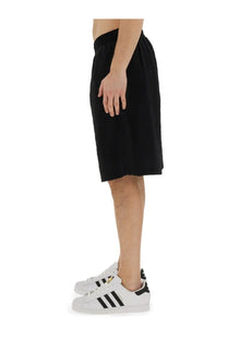 Family first men’s bermuda black adidas shorts with elastic waistband and relaxed straight-leg cut visible from the back