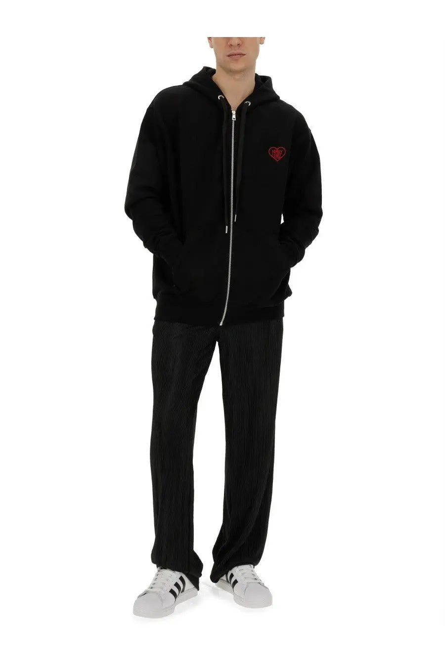 Black family first men’s pleated pants shown with a black zip-up hoodie featuring a red embroidered heart and silver zipper trim