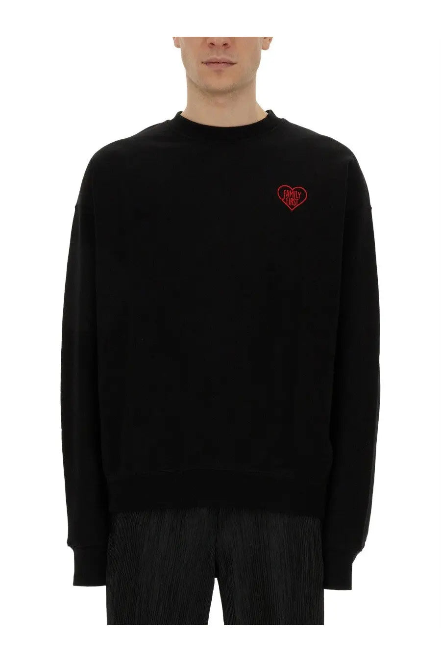 Black crewneck family first men’s sweatshirt with small red embroidered heart logo on the left chest