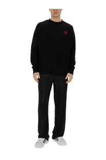 Family first men’s black long-sleeved sweatshirt with small red embroidered heart on left chest made of soft fabric