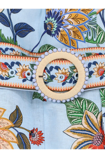 A light blue linen belt with floral print and a circular wooden buckle with small white beads for FARM Rio jumpsuit