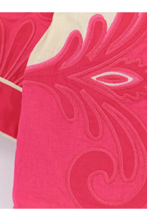 A vibrant pink embroidered cushion with cream border shown alongside farm rio women’s blue linen and viscose kimono
