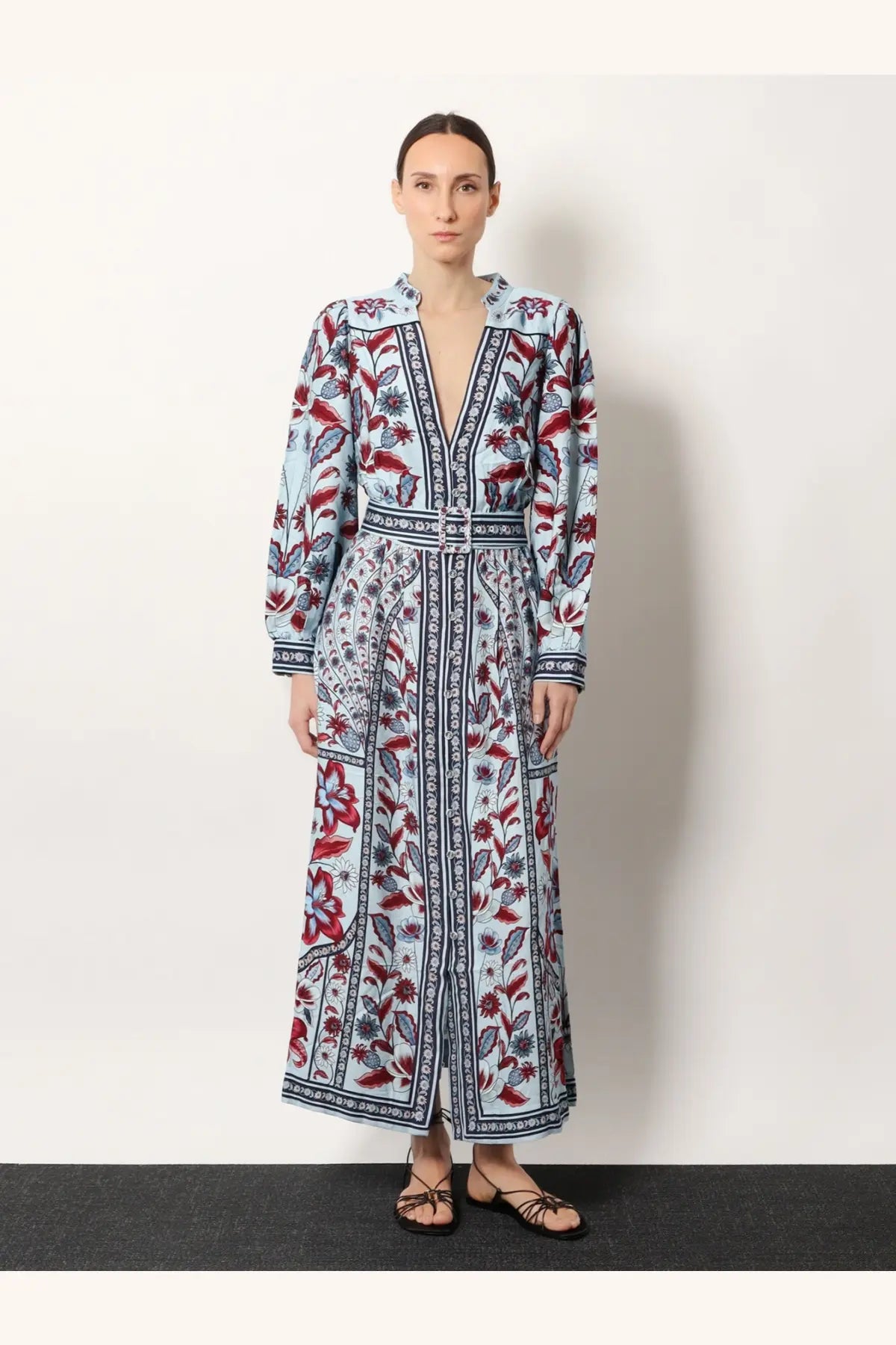 Farm Rio women’s Marcelle maxi dress in light blue with red and dark gray floral patterns, v-neckline, and belted waist