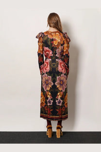 A woman wearing a dark green floral print viscose long dress with puffed sleeves and a matching belt by FARM Rio