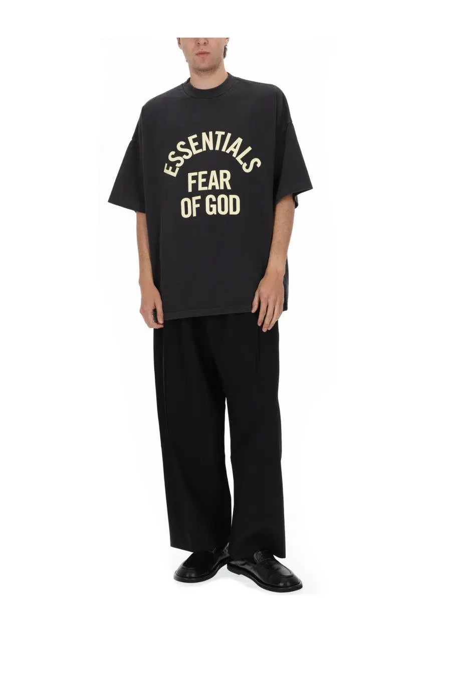 Black oversized fear of god essentials t shirt with cream arched lettering across the chest for casual wear